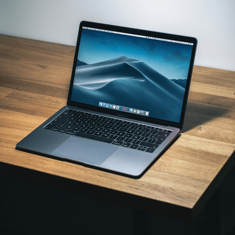 open macbook air on wooden desk