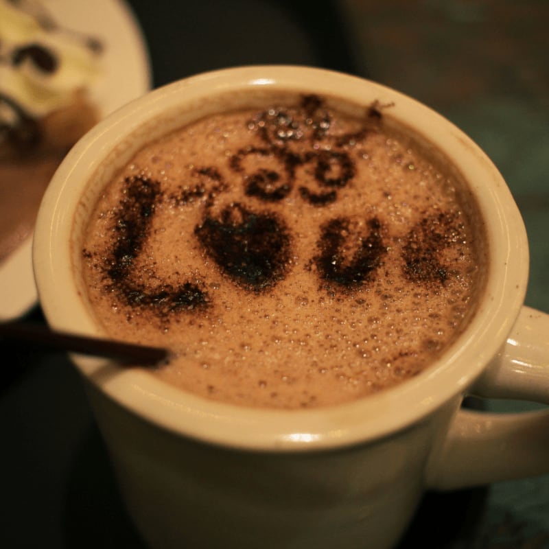a cup of hot chocolate with the word boo on it
