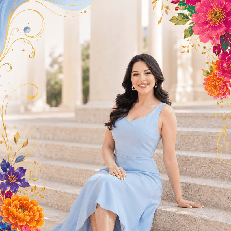 A woman in a light blue dress sits on stone steps, framed by colorful flowers and ornate golden swirls, with classical columns in the blurred background.