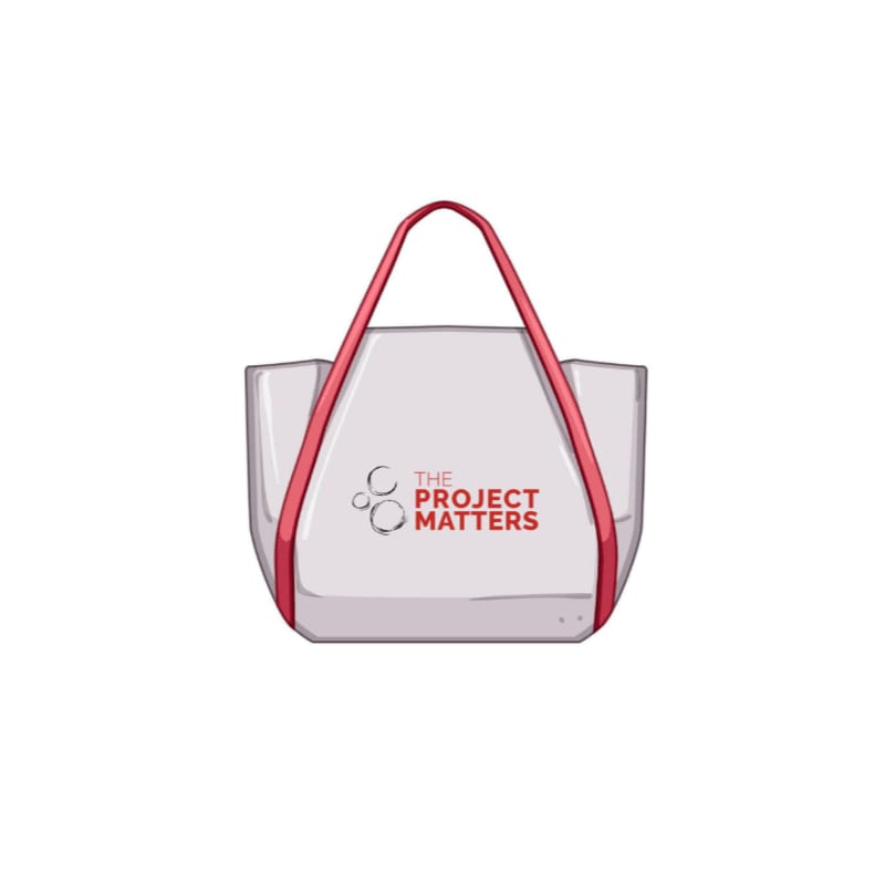 A white tote bag with red straps and the logo "THE PROJECT MATTERS" is centered against a plain white background.