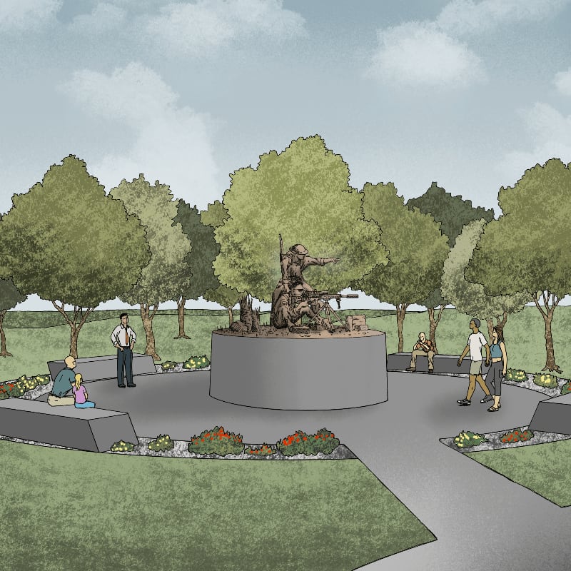 A bronze statue of soldiers stands on a circular pedestal in the foreground, surrounded by people and trees, with a cloudy sky in the background.