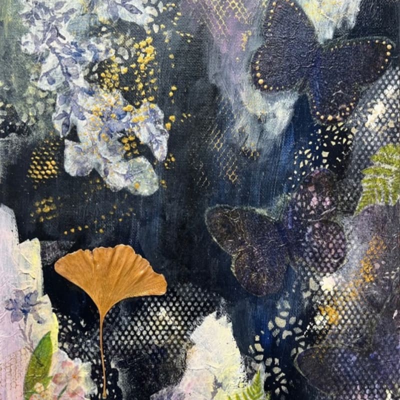 A single golden ginkgo leaf rests in the foreground against a dark, textured background filled with abstract floral elements and silhouetted butterflies.
