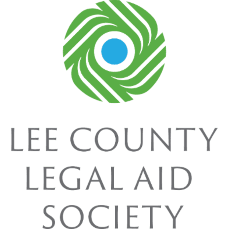 A green circular logo with a blue center is positioned above the gray text "LEE COUNTY LEGAL AID SOCIETY" on a white background.