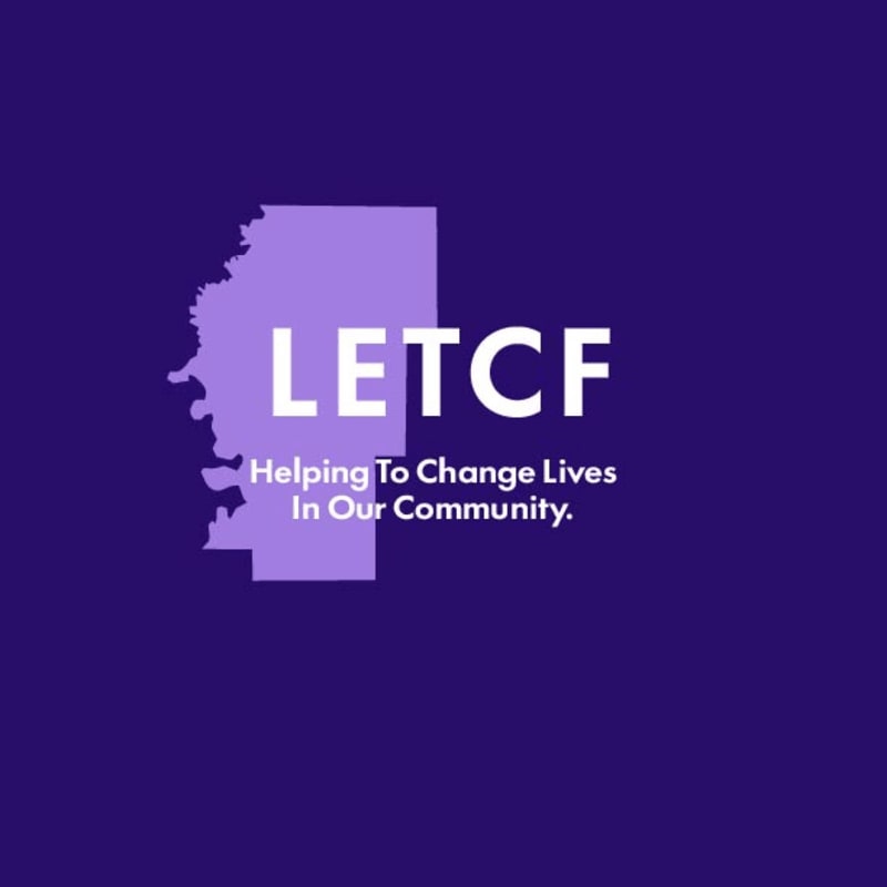 A purple background frames a light purple outline of Mississippi with the white text "LETCF Helping To Change Lives In Our Community."
