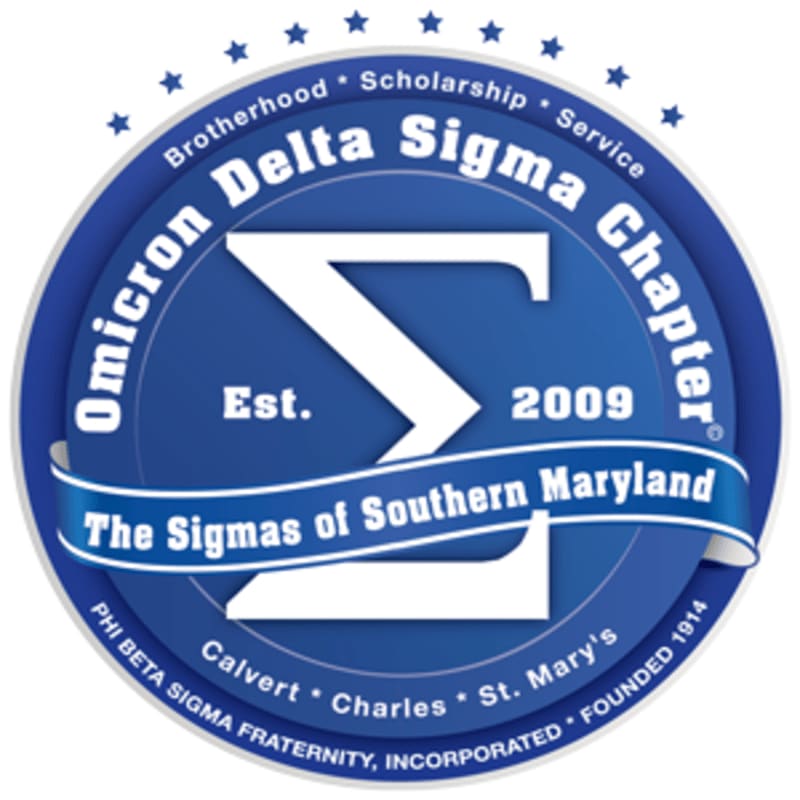 A blue circular emblem with a white Sigma symbol in the foreground features the text "Omicron Delta Sigma Chapter," "Est. 2009," and "The Sigmas of Southern Maryland," while the background displays "Brotherhood," "Scholarship," "Service," and "PHI BETA SIGMA FRATERNITY, INCORPORATED FOUNDED 1914" along with county names.