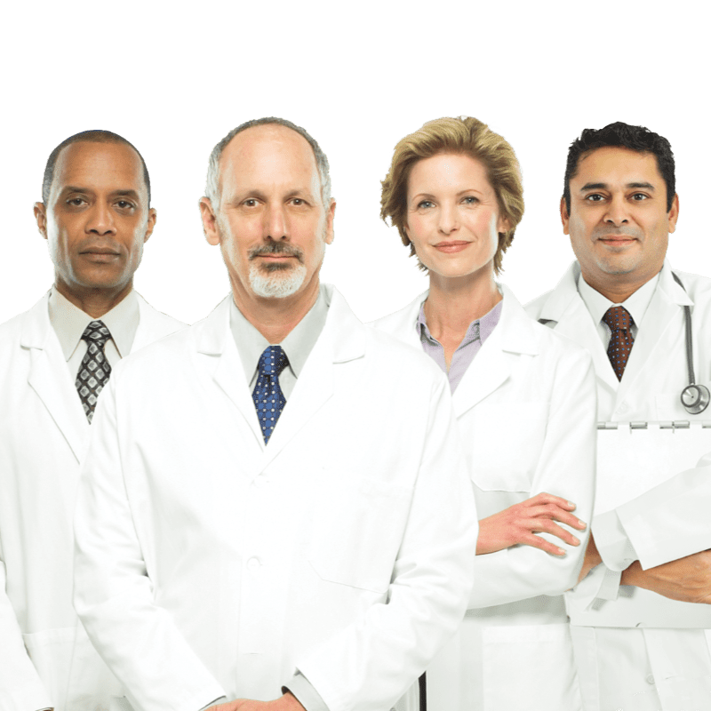 Four doctors in white coats stand against a plain white background, with the two men in the foreground looking directly at the camera.