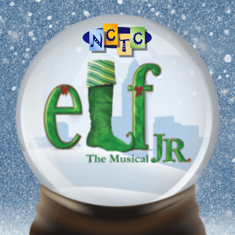 A snow globe with the word "elf" and "JR." inside, featuring a green elf boot and a city skyline, sits against a snowy blue background.