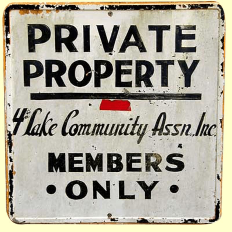 A weathered, white metal sign with black lettering stating "PRIVATE PROPERTY 4 Lake Community Assn. Inc. MEMBERS ONLY" is set against a plain yellow background.