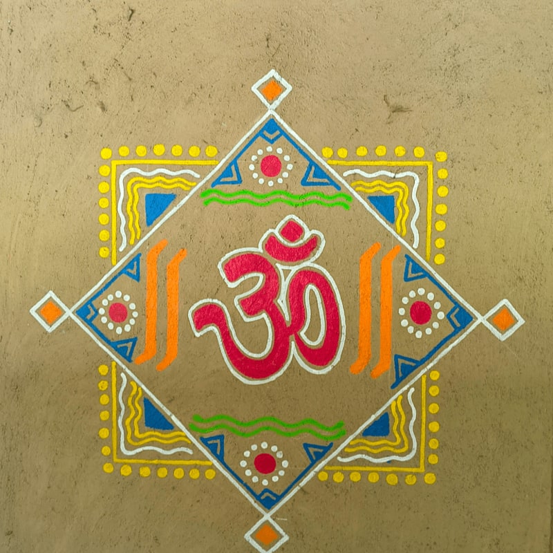 Colorful rangoli design with the sacred om symbol.