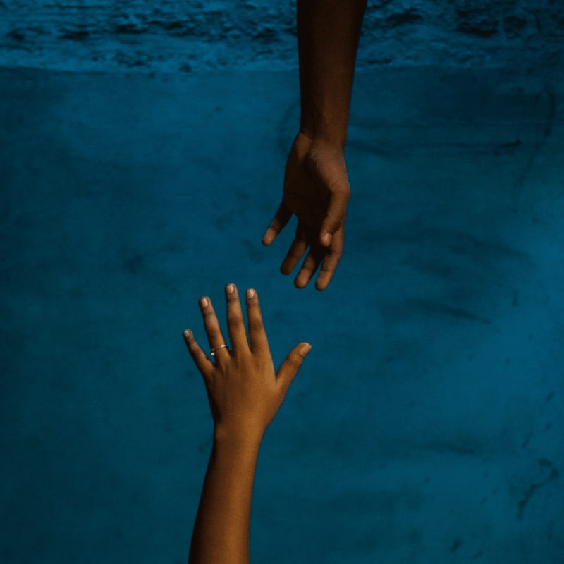 a pair of hands on a blue surface
