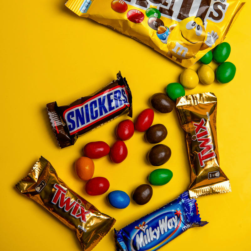 A variety of candy on a yellow background