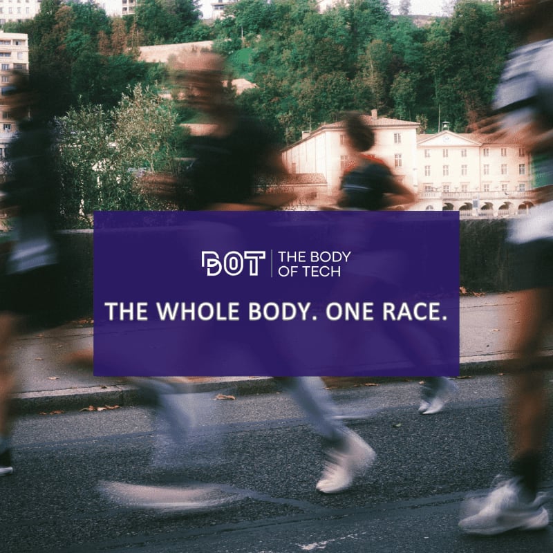 Blurry runners race on a street in the foreground, with a building and trees visible in the background.
