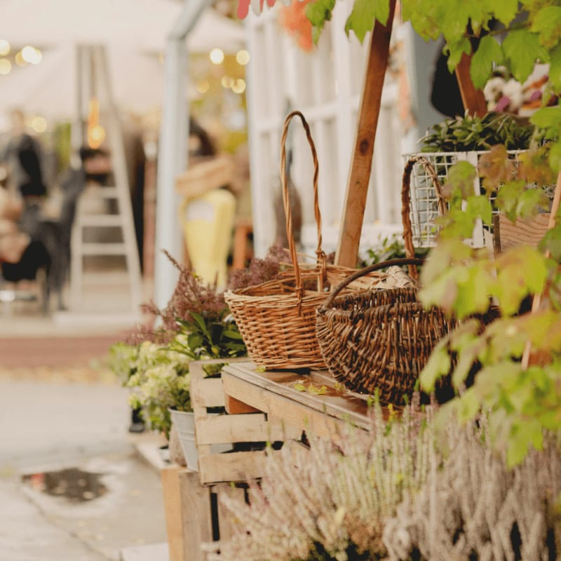 Outdoor market stall with flowers and baskets