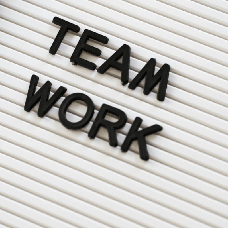 a sign that says team work on it