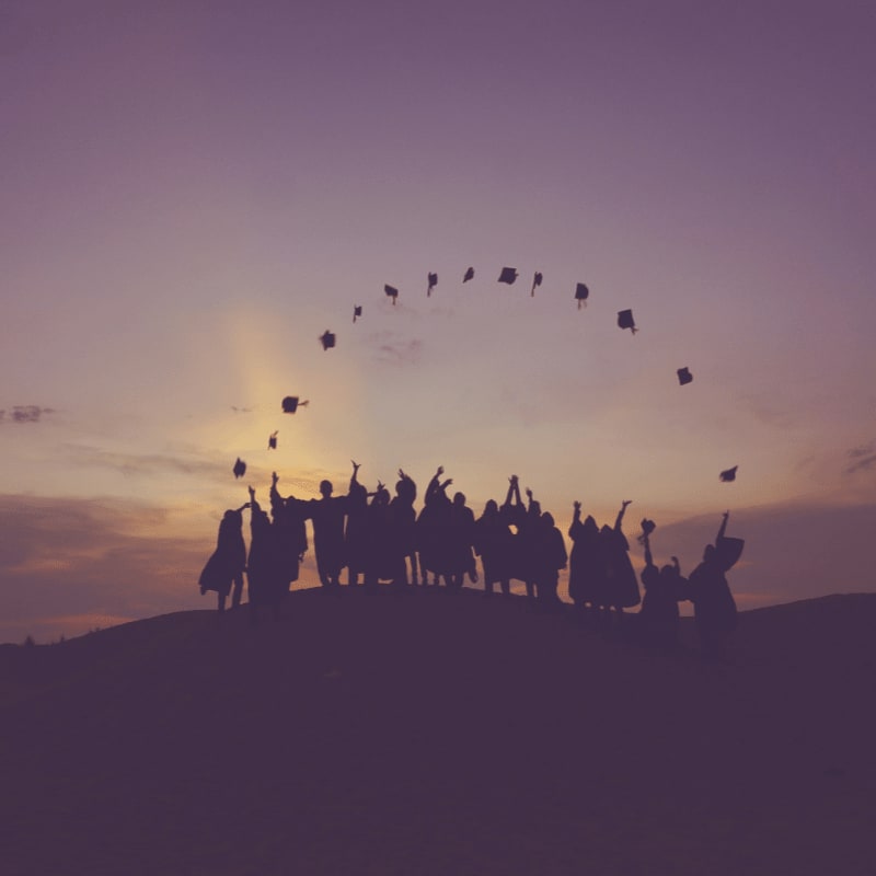 silhouette of people standing on hill