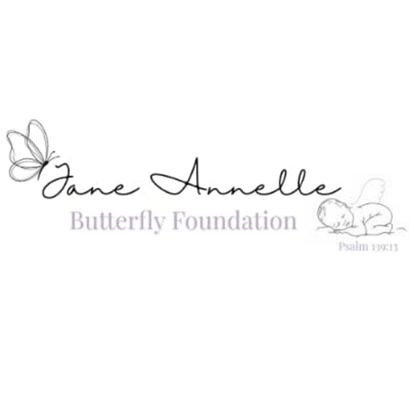A delicate butterfly and elegant script spell out "Jane Annelle Butterfly Foundation" in the foreground, with a faint outline of a sleeping baby and a Bible verse in the background.
