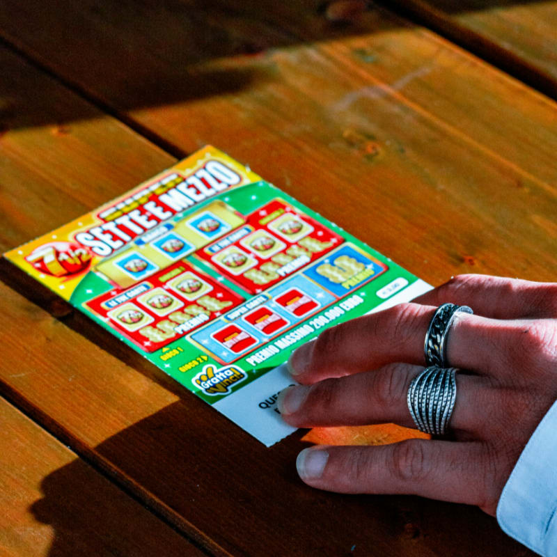 person in white long sleeve shirt holding white and red box