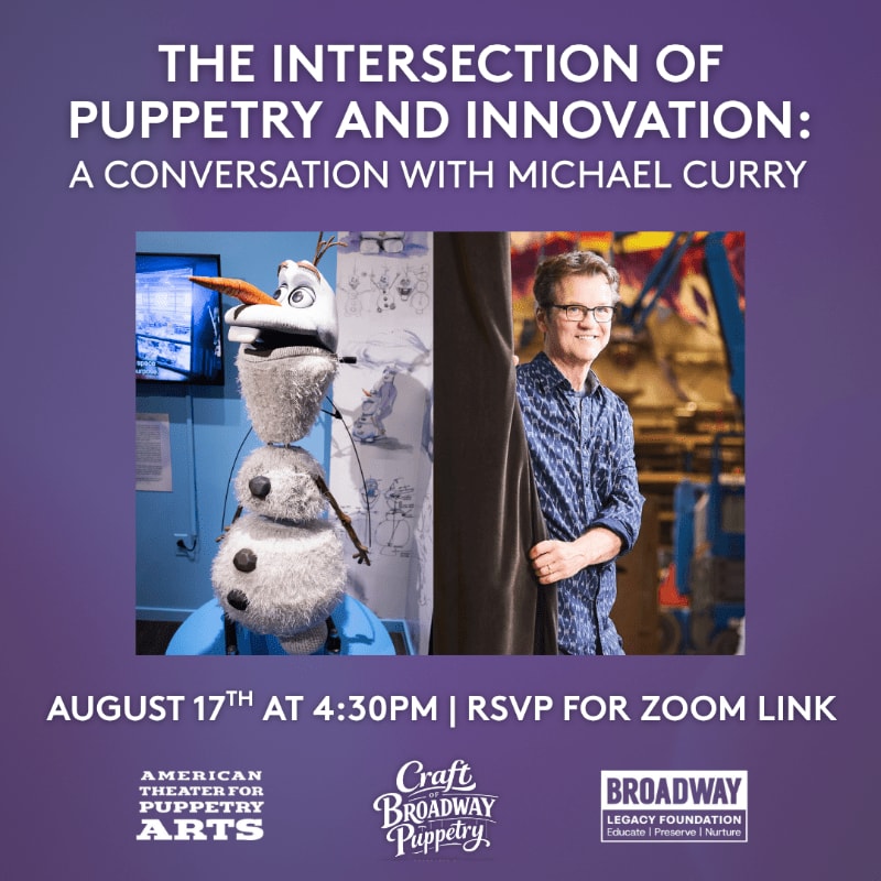 A puppet resembling Olaf from Frozen stands in the foreground, while Michael Curry smiles from behind a curtain in the background.