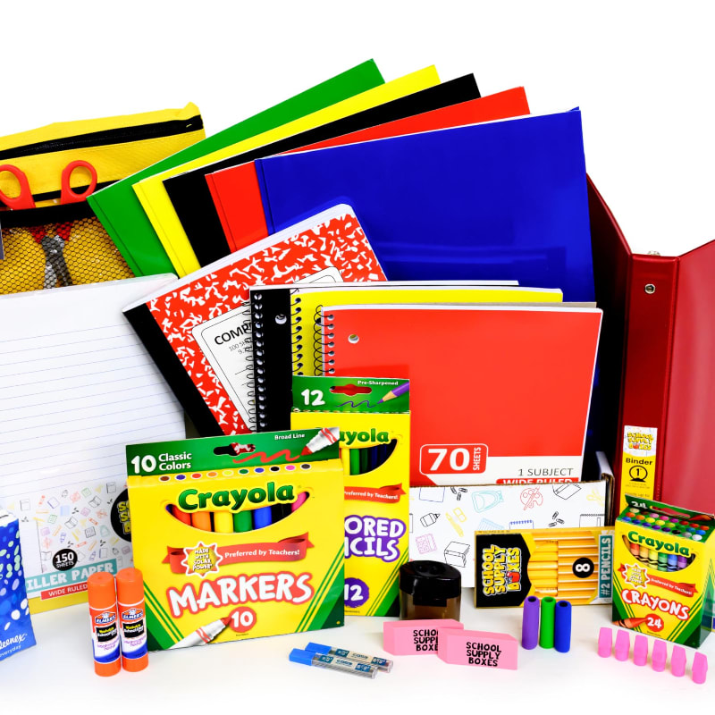 In the foreground, a collection of colorful school supplies like markers, crayons, pencils, and glue sticks are arranged, while the background features a stack of notebooks and binders in various bright colors.