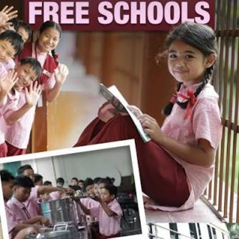 A young girl reads a book in the foreground while a group of smiling children wave in the background, with the words "FREE SCHOOLS" displayed above them.