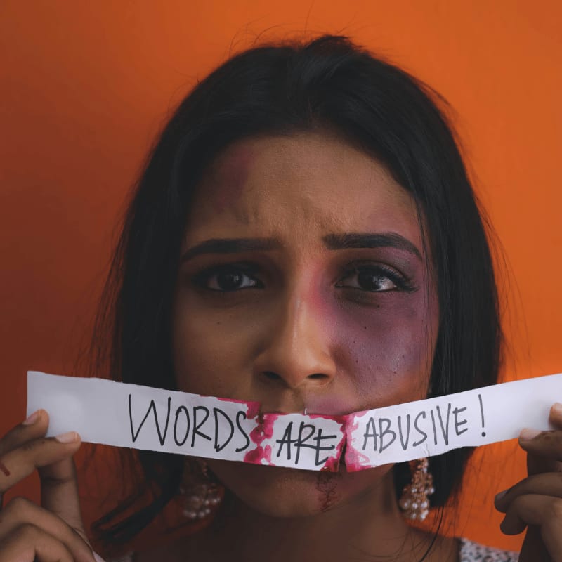 a woman holding a piece of paper with words on it