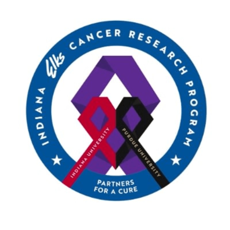 A circular logo for the Indiana Elks Cancer Research Program features intertwined purple, red, and black ribbons in the foreground, with text around the perimeter and stars on a blue background in the background.