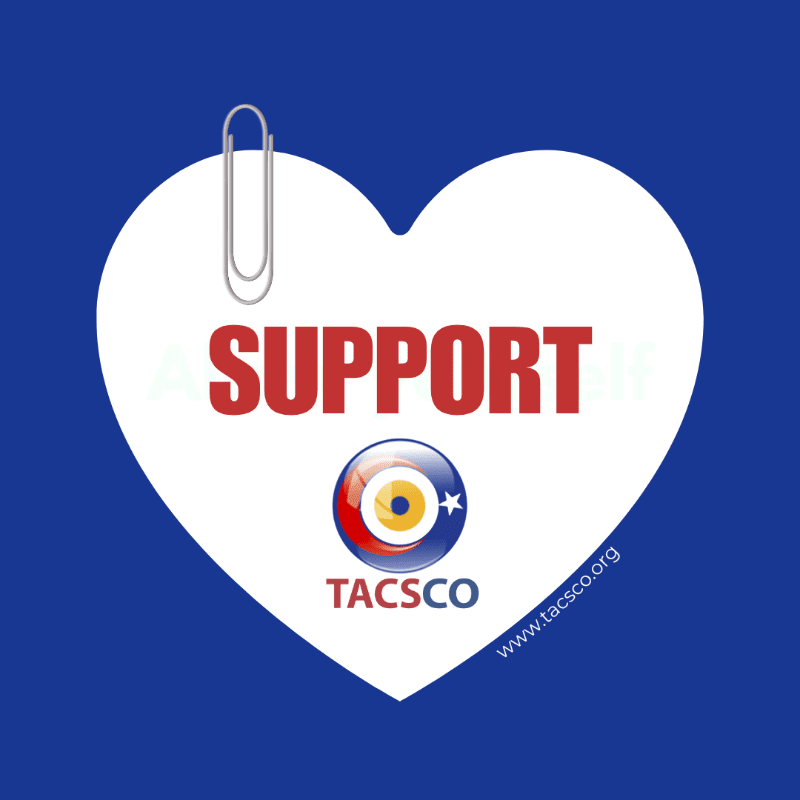 A white heart with "SUPPORT" written in red and a TACSCO logo is pinned to a blue background.