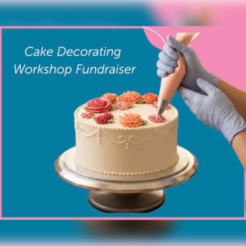 A gloved hand pipes frosting onto a decorated cake in the foreground, with a pink and blue background featuring text that reads "Cake Decorating Workshop Fundraiser."