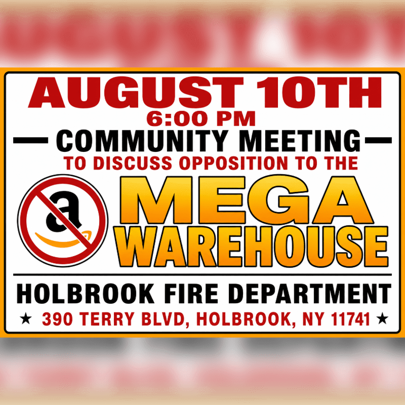 A community meeting sign in the foreground announces opposition to a "Mega Warehouse" at the Holbrook Fire Department, with a blurred, warm-toned background.