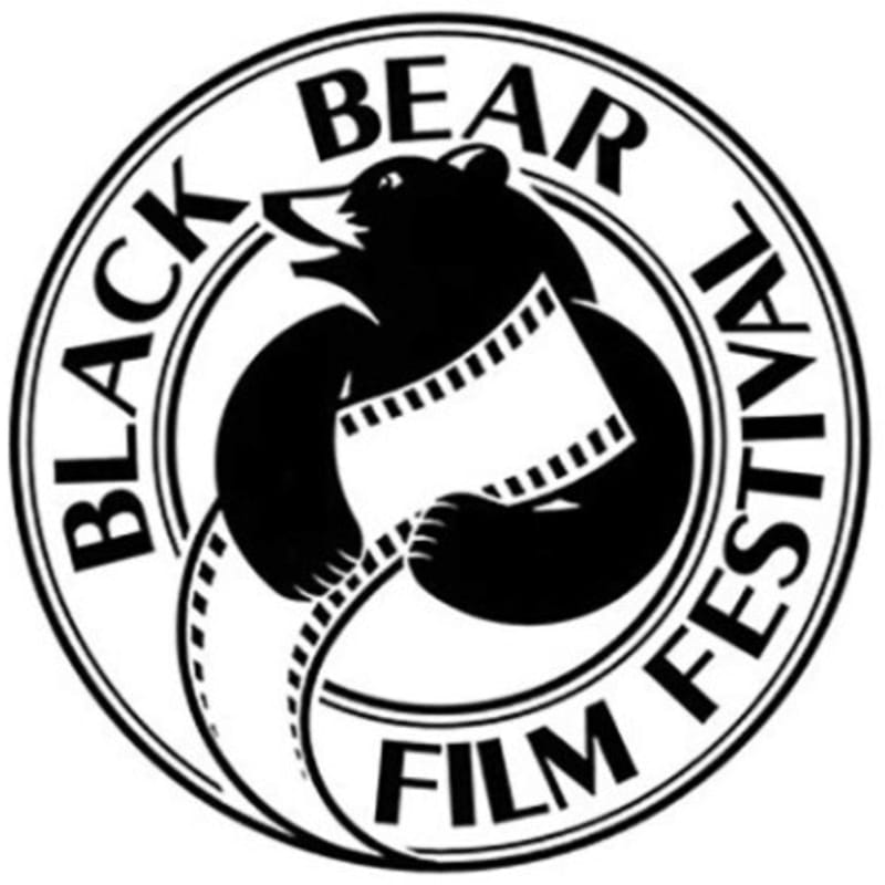A black and white circular logo features a bear holding a film strip in the foreground, with the words "BLACK BEAR FILM FESTIVAL" encircling the bear in the background.
