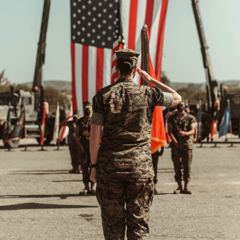 a group of people in military uniforms holding american flags