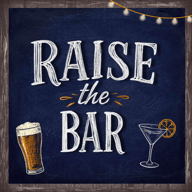 A pint of beer and a martini glass sit on a chalkboard with the words "RAISE the BAR" written in chalk, framed by string lights.