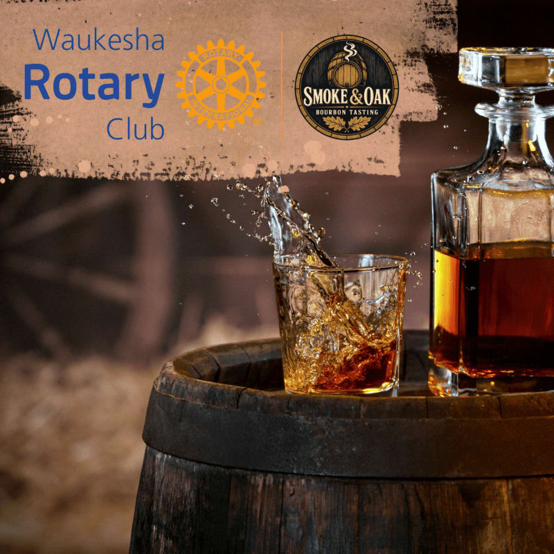 A glass of whiskey is being poured from a decanter onto a wooden barrel in the foreground, with the Waukesha Rotary Club and Smoke & Oak logos visible in the blurred background.