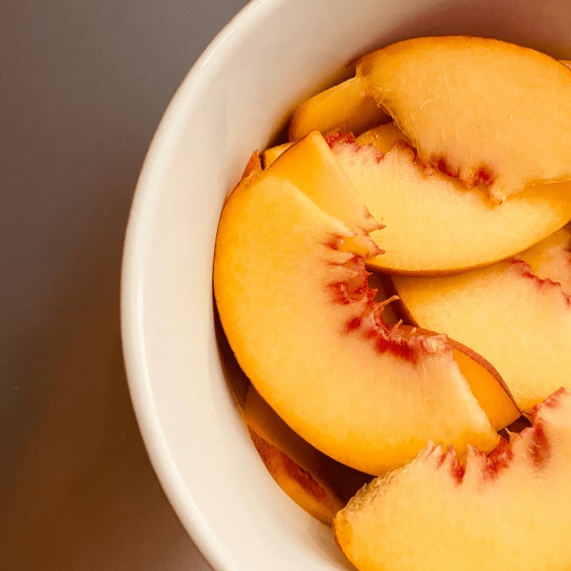 sliced fruit in white ceramic bowl
