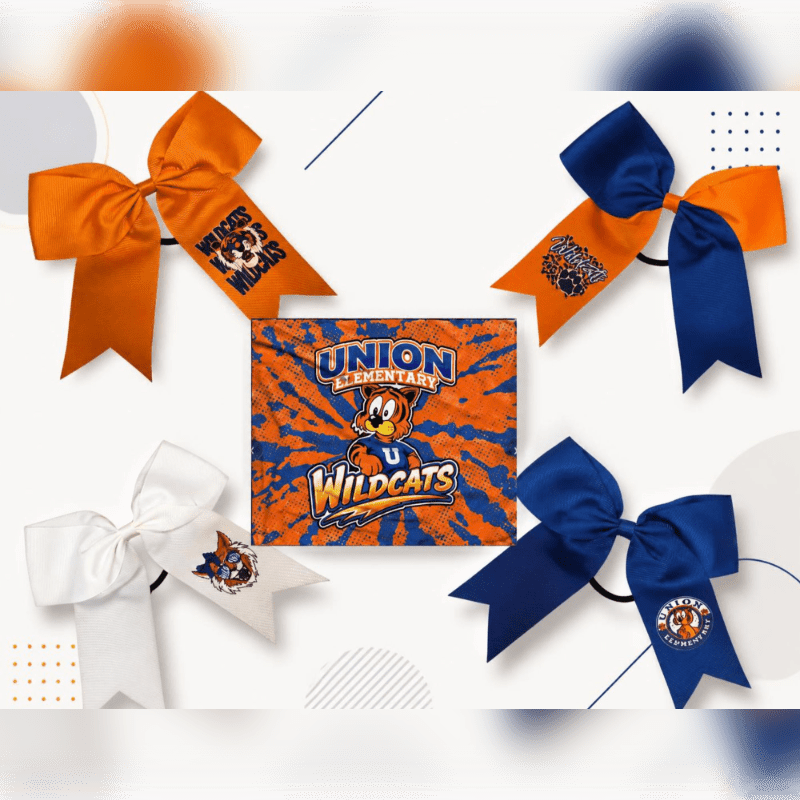 Four cheer bows, two orange and two blue, and one white bow are arranged around a central square fabric featuring the "Union Elementary Wildcats" mascot, all set against a light background with abstract lines and dots.