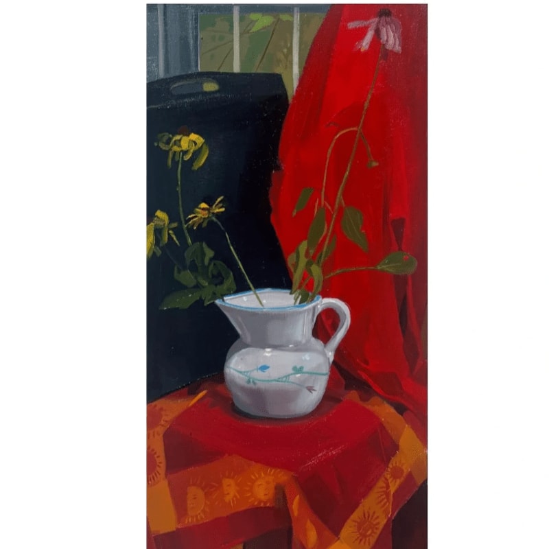 A white pitcher with blue floral accents sits on a red tablecloth in the foreground, with a black bag and yellow flowers to its left and a red drape to its right, all set against a window in the background.