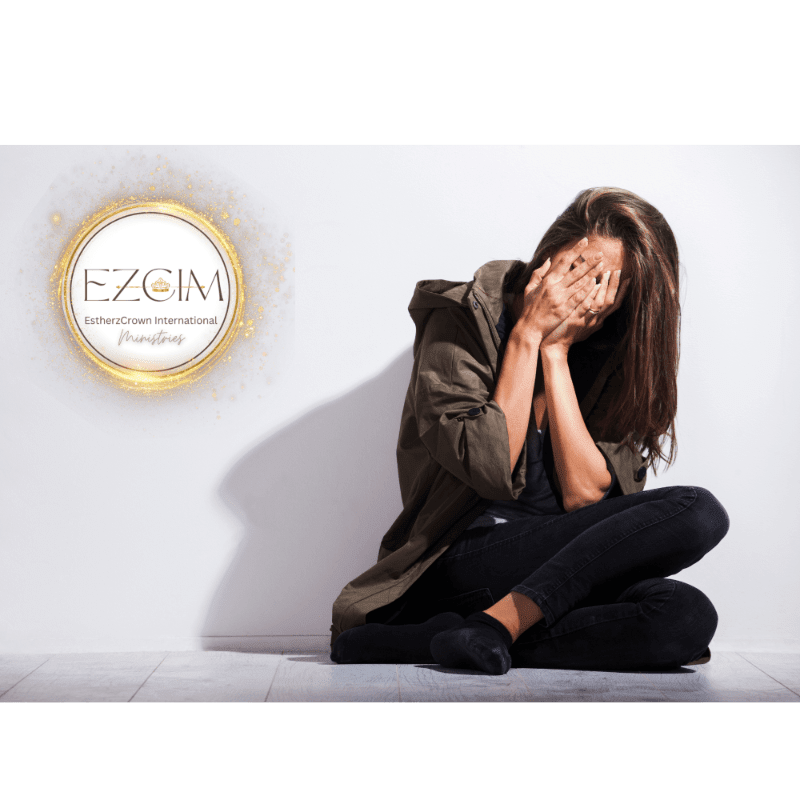A distressed woman sits on the floor with her face buried in her hands, while a circular logo with the text "EZCIM" is visible on the white wall behind her.