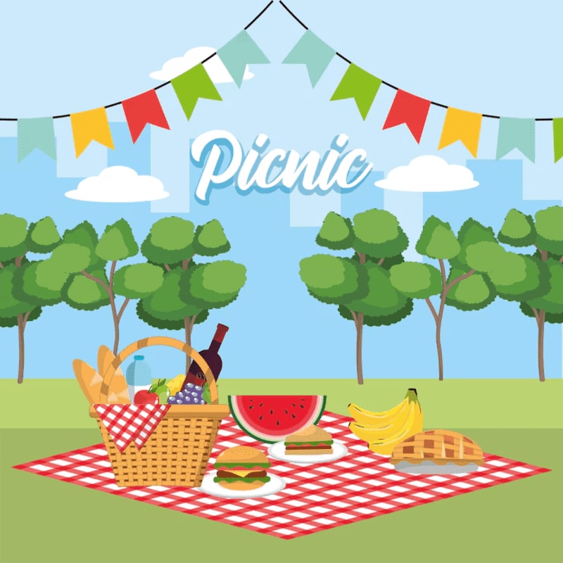 A checkered blanket in the foreground holds a picnic basket, watermelon, sandwiches, bananas, and pie, set against a background of trees, a blue sky with clouds, and colorful bunting.