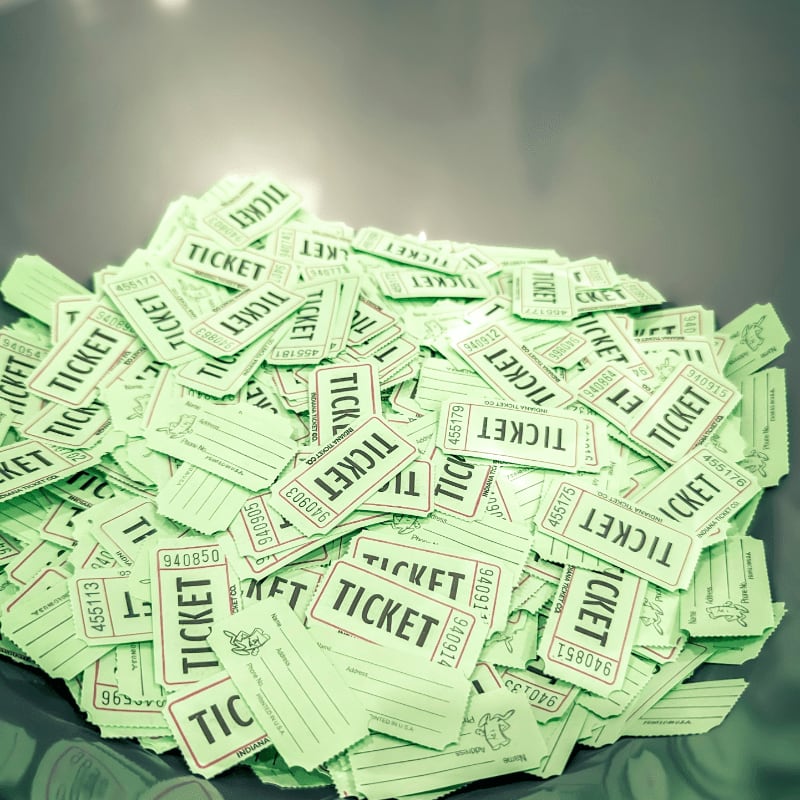 a bowl full of tickets sitting on top of a table