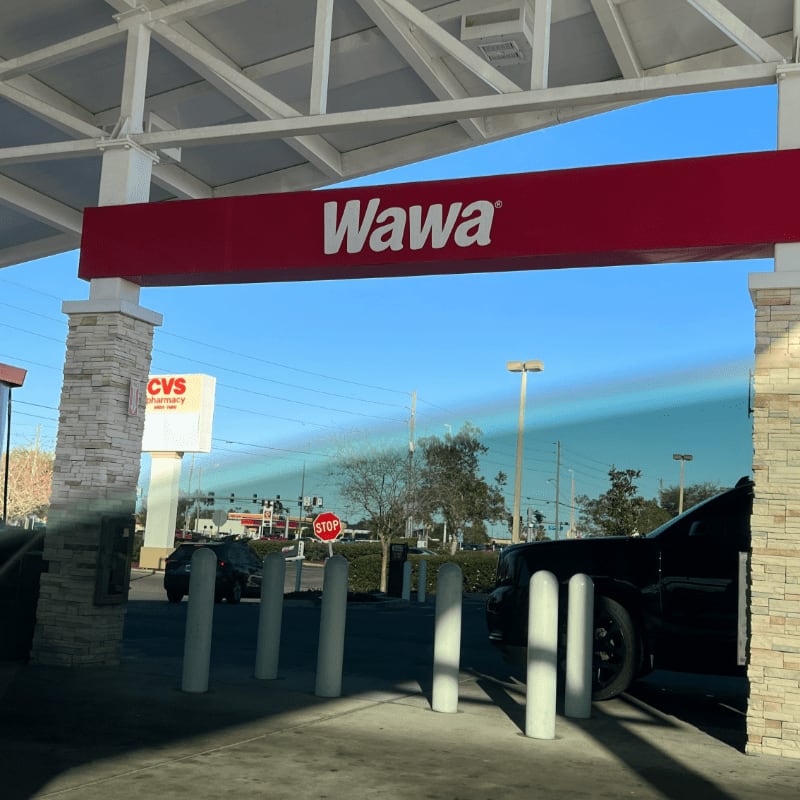 a red and white sign that reads wawa
