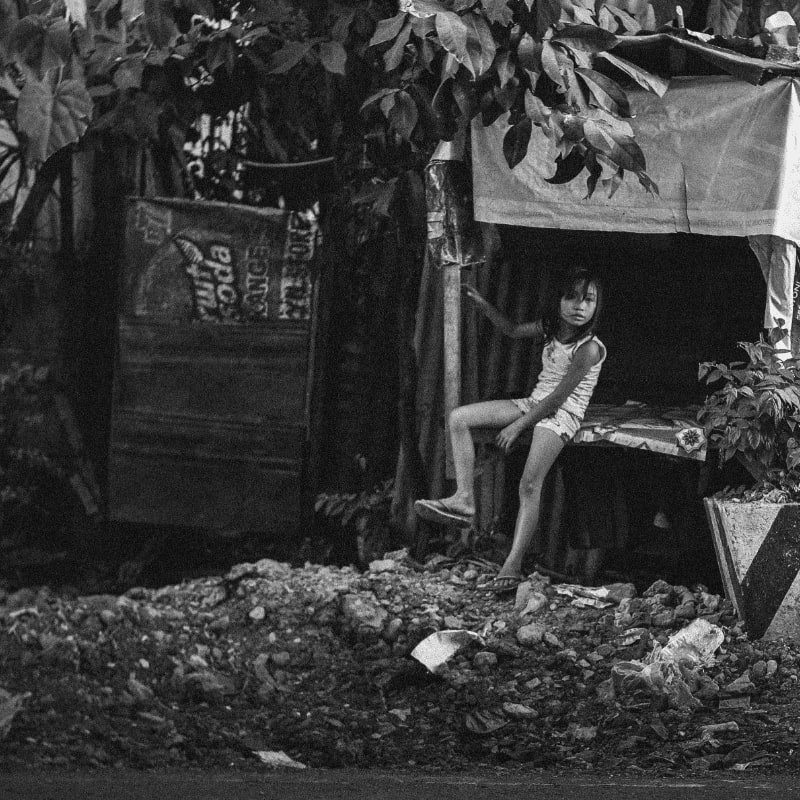 grayscale photography of girl sitting under tree