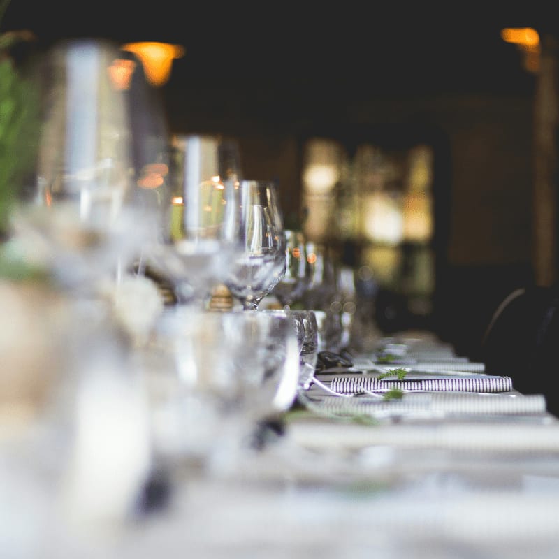 focused photo of wine glasses lined on table