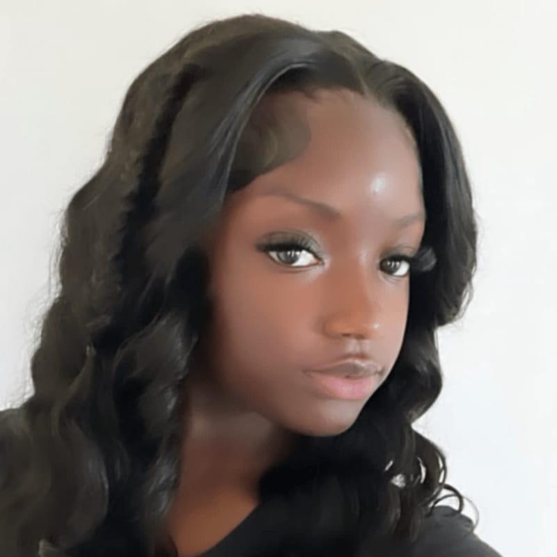 A young woman with dark, wavy hair is looking forward against a plain white background.