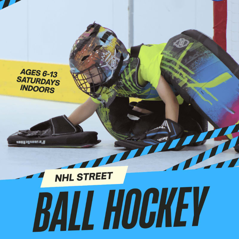 A young goalie in full gear crouches on an indoor court with a "NHL STREET BALL HOCKEY" banner in the foreground and a yellow sign indicating "AGES 6-13 SATURDAYS INDOORS" in the background.