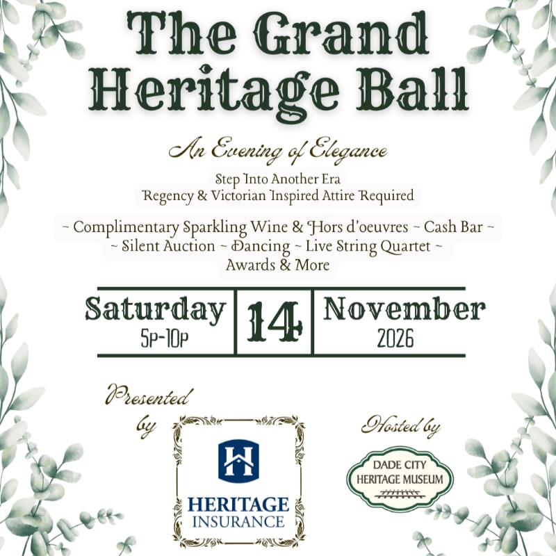 A vintage-style invitation for "The Grand Heritage Ball" is set against a background of delicate green foliage.