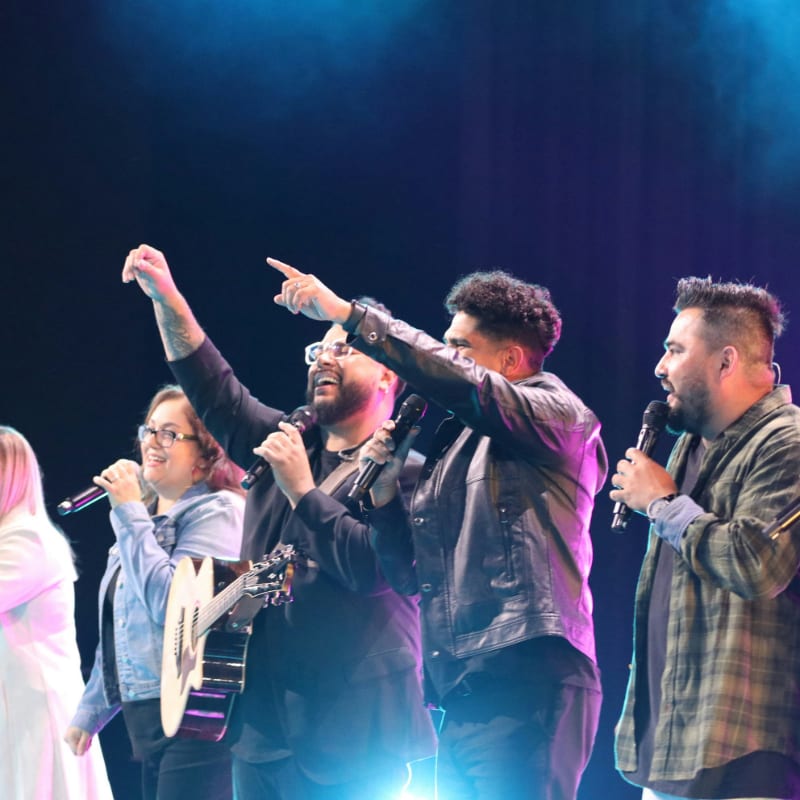 a group of people standing on top of a stage