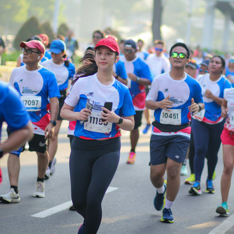 A large group of people running down a street