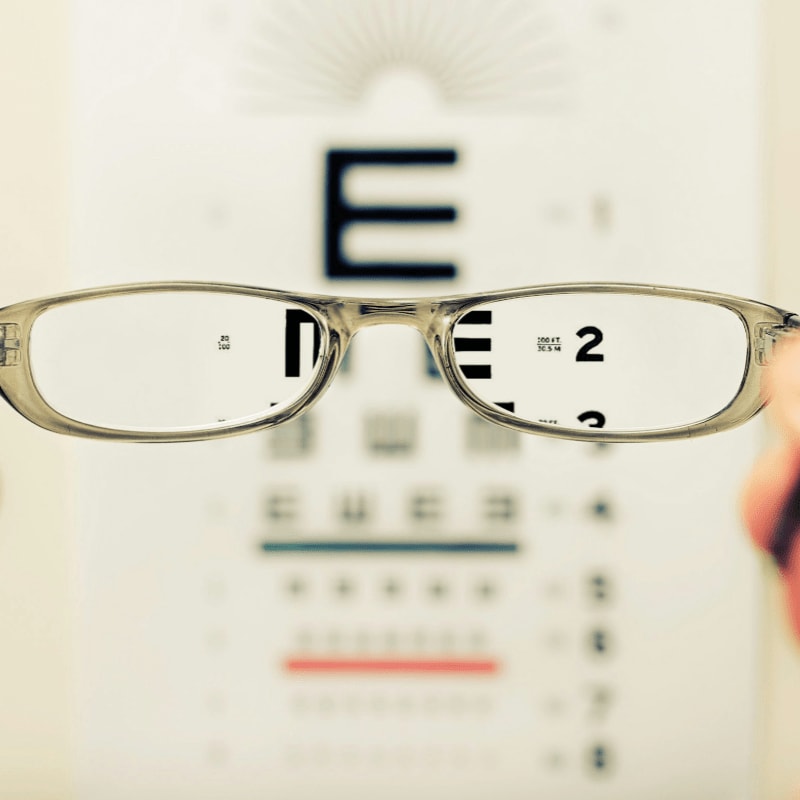 person holding eyeglasses