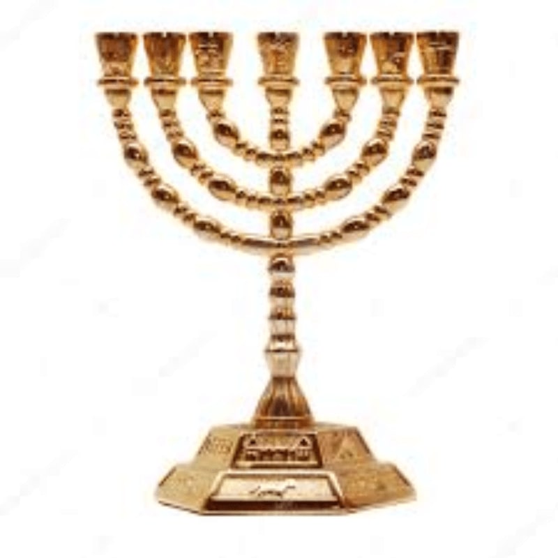 A golden menorah with seven candle holders stands on a decorative base against a plain white background.