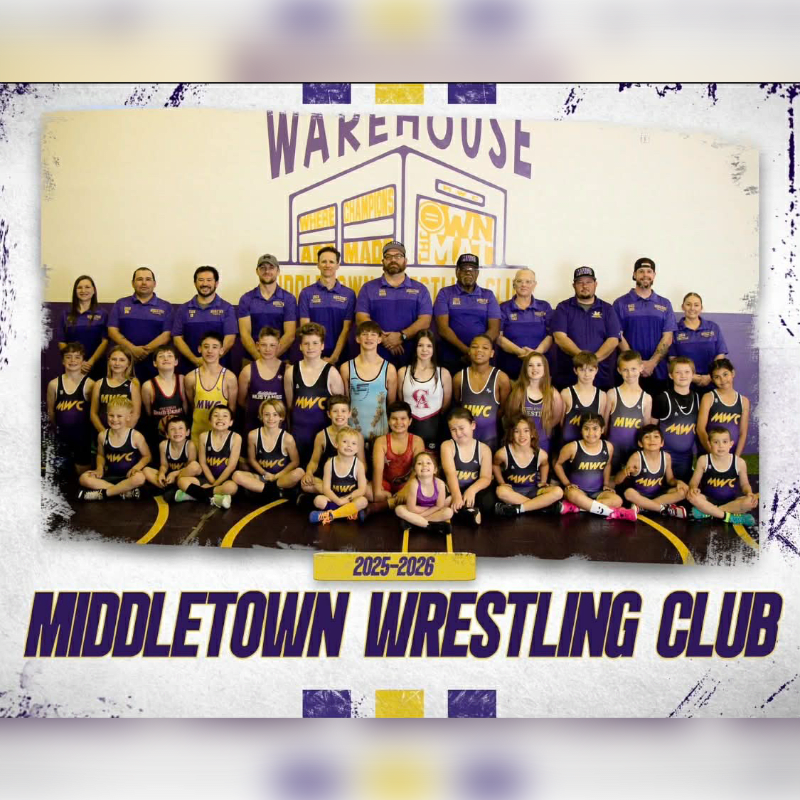 A wrestling team poses for a photo in front of a building with "Warehouse" signage, with the "Middletown Wrestling Club" title displayed below.